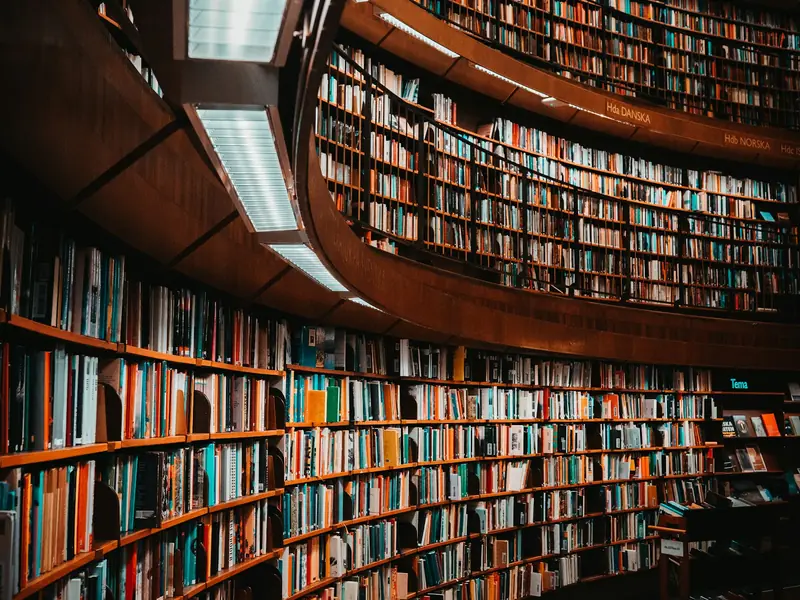 Curved wooden shelves full of books in a library