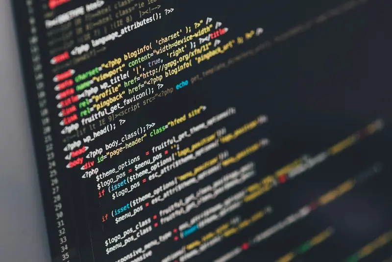Close-up of colourful source code on a dark screen