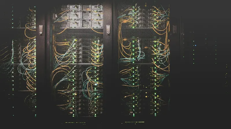 Server racks with bundles of network cables and green status lights