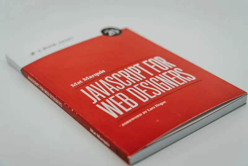 The red paperback “JavaScript for Web Designers” by Mat Marquis